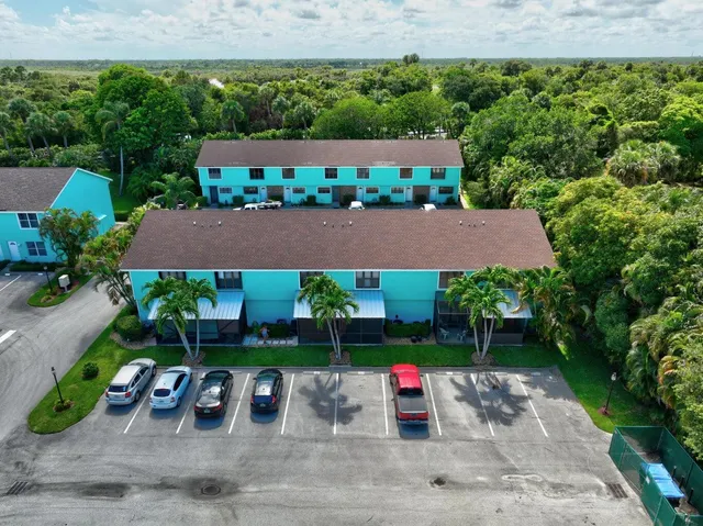 a view of a chairs and table in the backyard