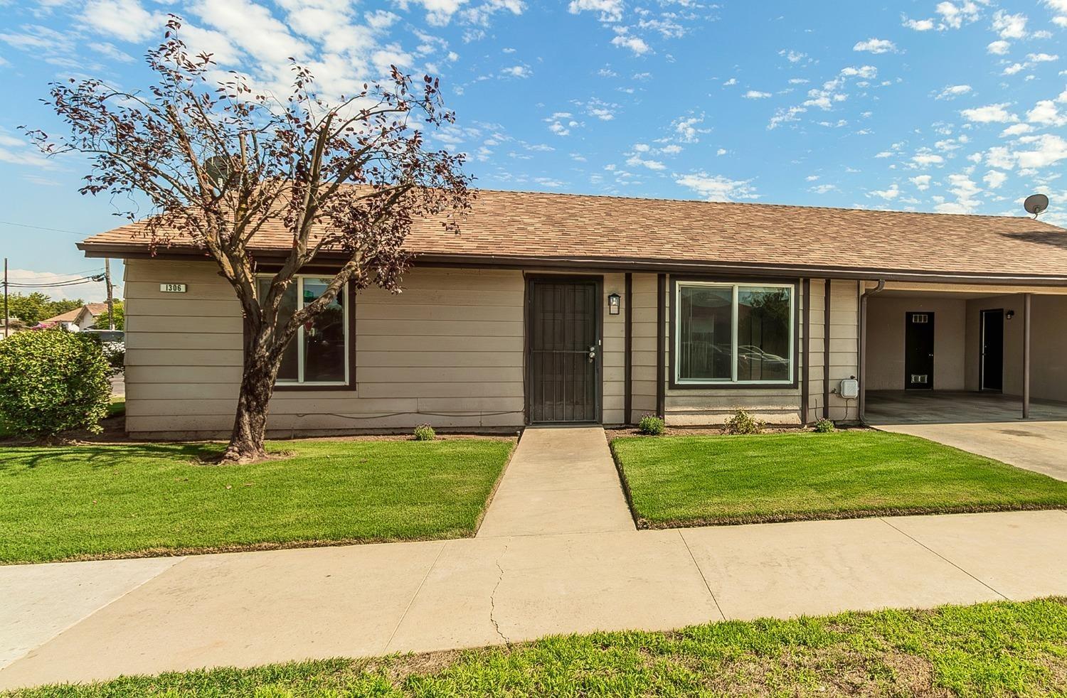 1306 13th Street Reedley, CA 93654 - Photo 2 of 14 a front view of a house with a garden