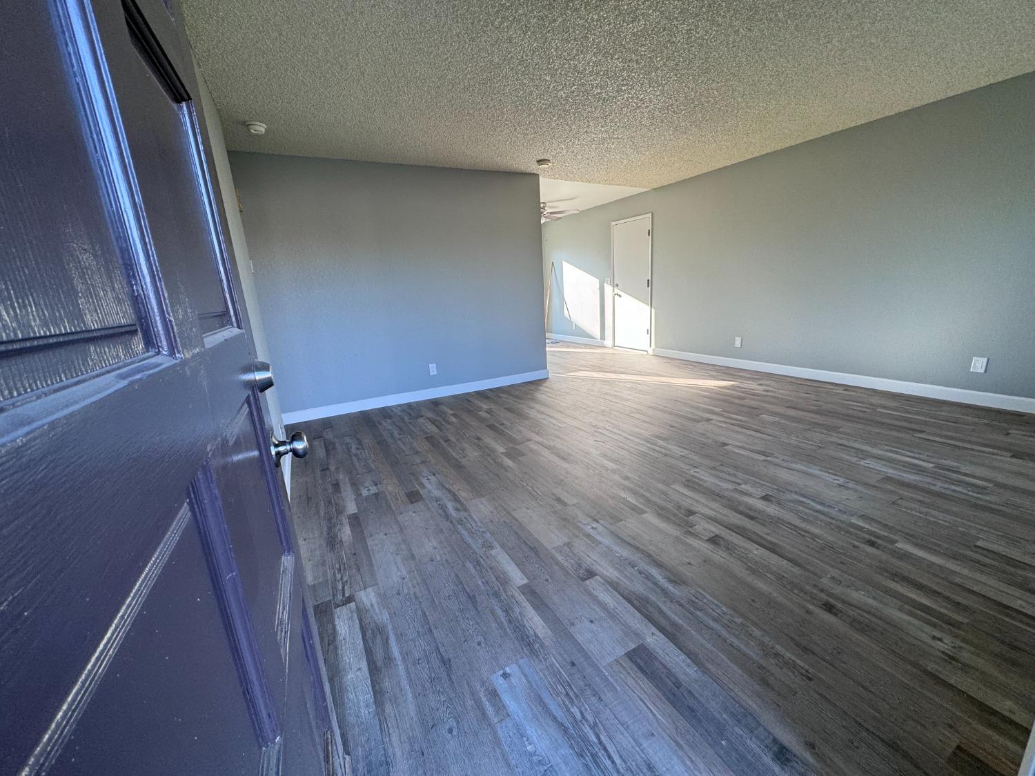1306 13th Street Reedley, CA 93654 - Photo 5 of 14 a view of a room with wooden floor and window
