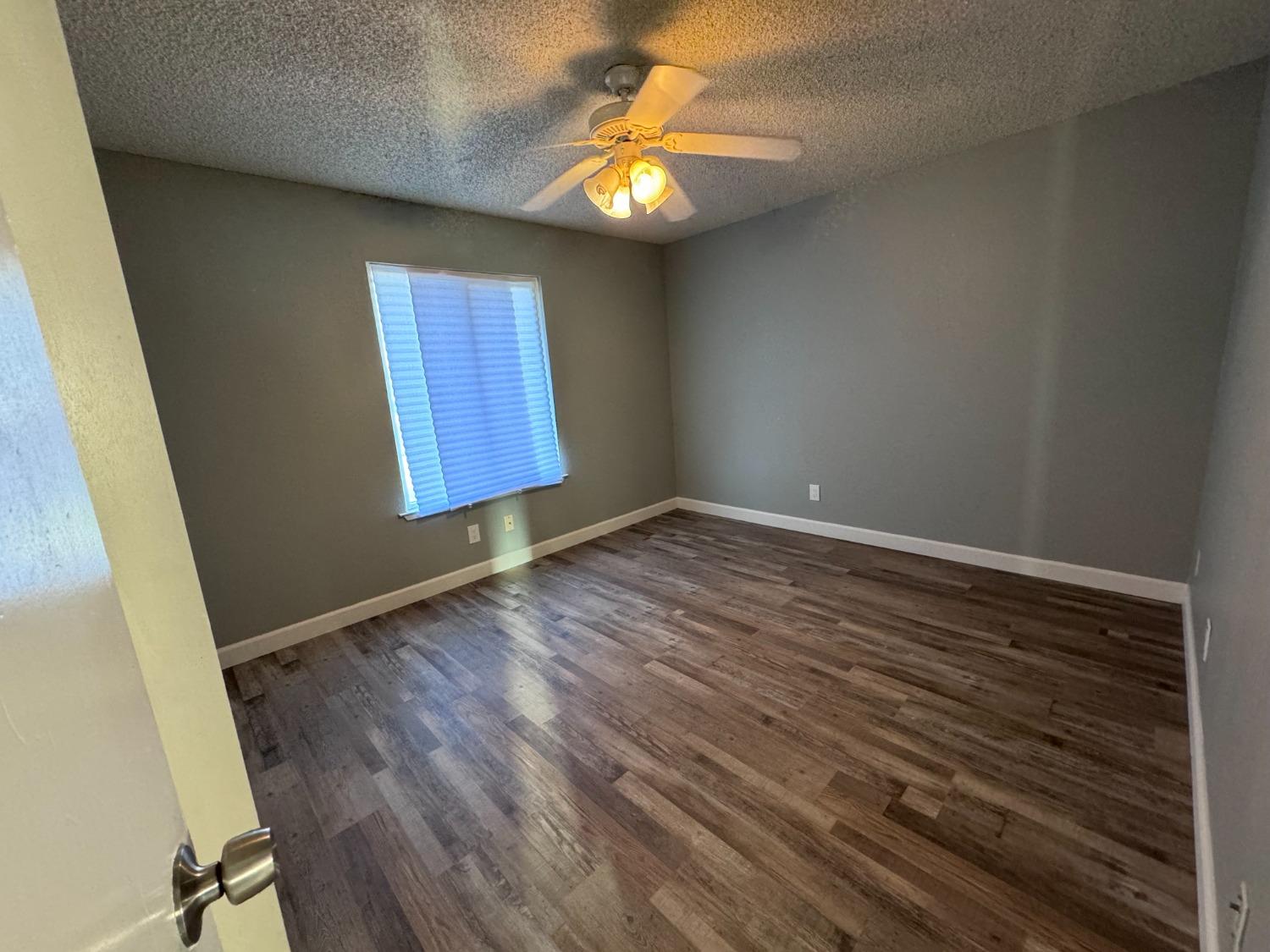 1306 13th Street Reedley, CA 93654 - Photo 6 of 14 a view of an empty room and window