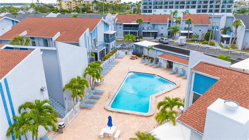 230 Medallion Boulevard, Unit E Madeira Beach, FL 33708 - Photo 23 of 35 an aerial view of residential houses with plants and lake view