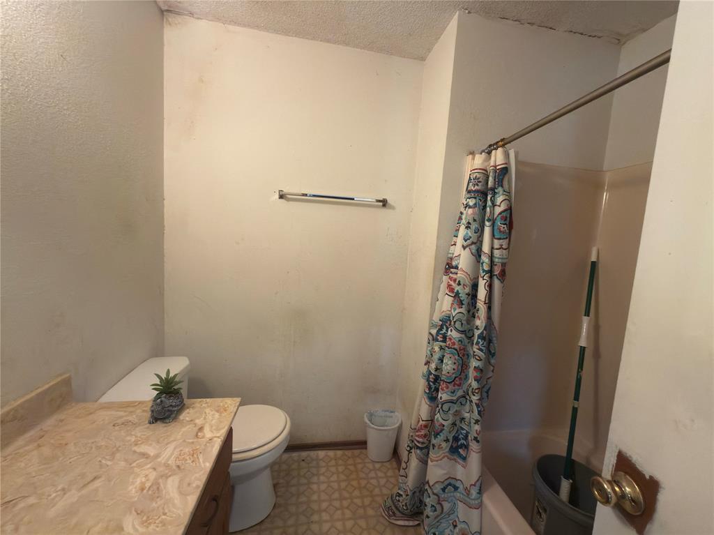 12776 Valverde Loop Terrell, TX 75161 - Photo 16 of 36 a bathroom with a granite countertop sink toilet and shower