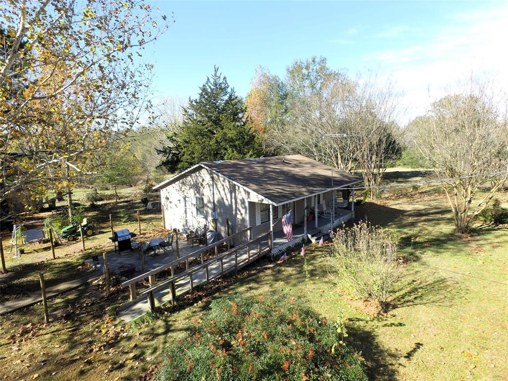 12776 Valverde Loop Terrell, TX 75161 - Photo 29 of 36 a aerial view of a house with swimming pool and large trees