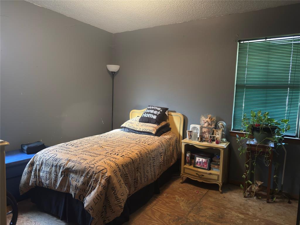12776 Valverde Loop Terrell, TX 75161 - Photo 30 of 36 a bedroom with a bed and a fireplace