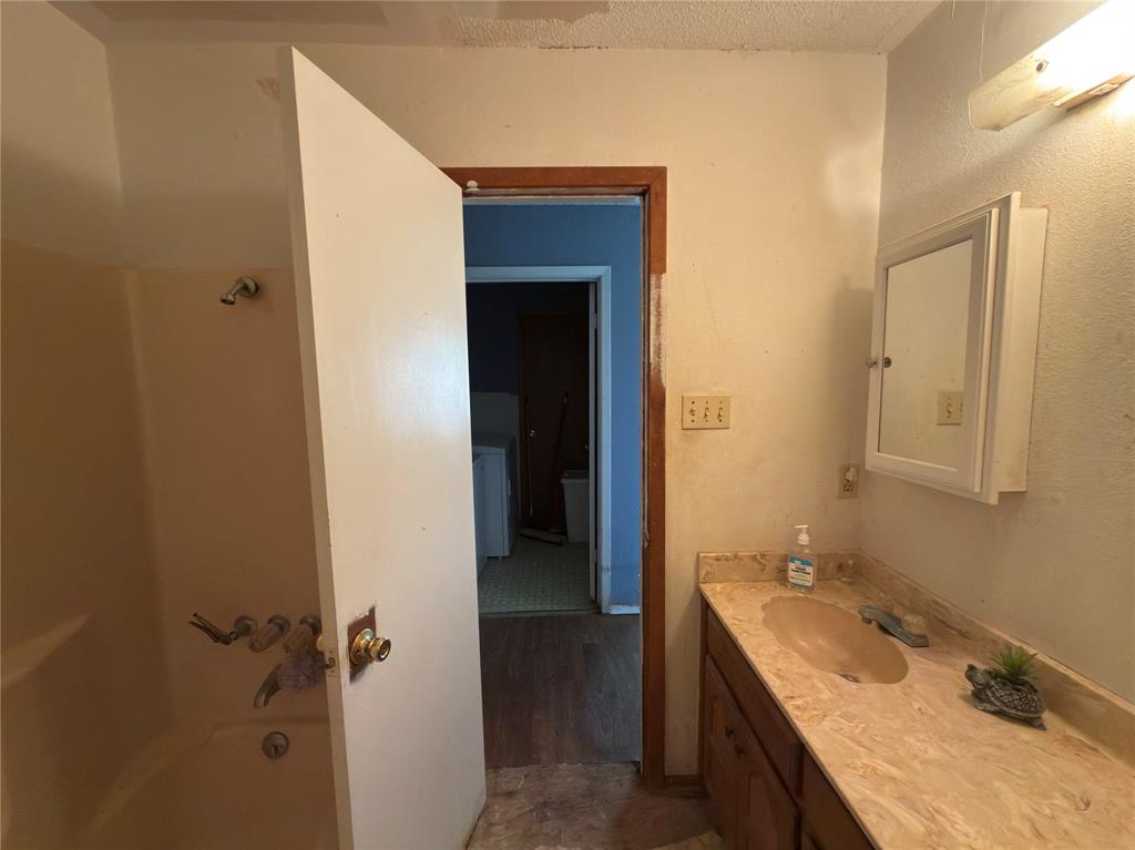 12776 Valverde Loop Terrell, TX 75161 - Photo 36 of 36 a bathroom with a granite countertop tub sink and mirror