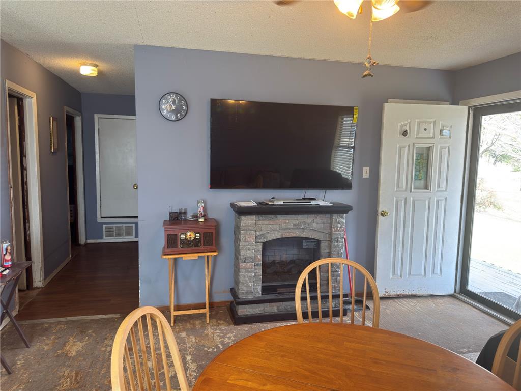 12776 Valverde Loop Terrell, TX 75161 - Photo 6 of 36 a living room with furniture a flat screen tv and a fireplace