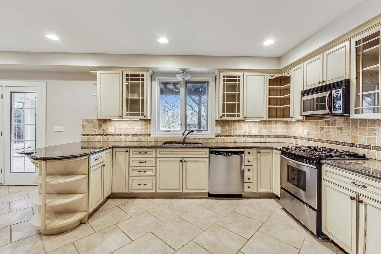 22206 North Prairie Lane Kildeer, IL 60047 - Photo 32 of 34 a kitchen with stainless steel appliances granite countertop a stove top oven a sink dishwasher and granite countertops
