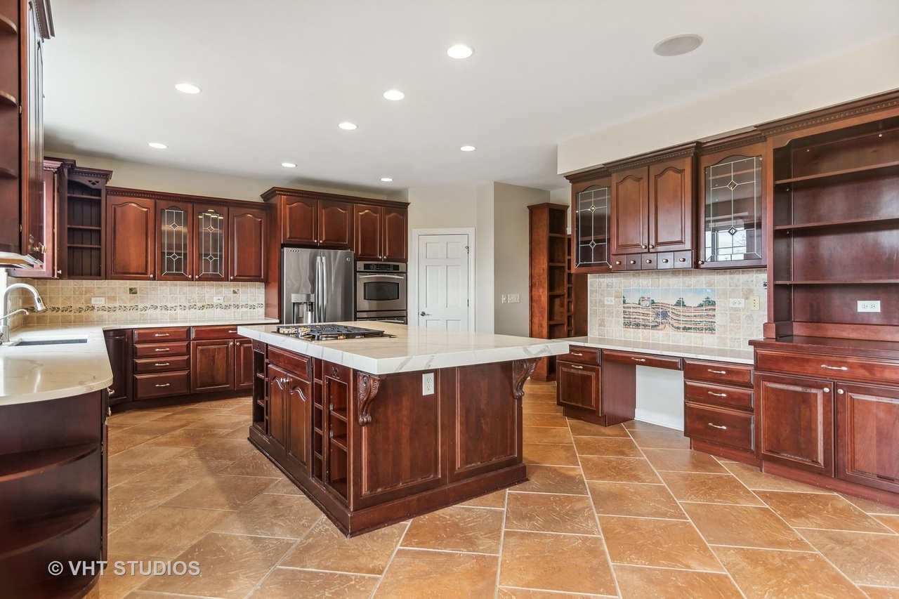 22206 North Prairie Lane Kildeer, IL 60047 - Photo 9 of 34 a kitchen with stainless steel appliances granite countertop wooden cabinets a sink and dishwasher