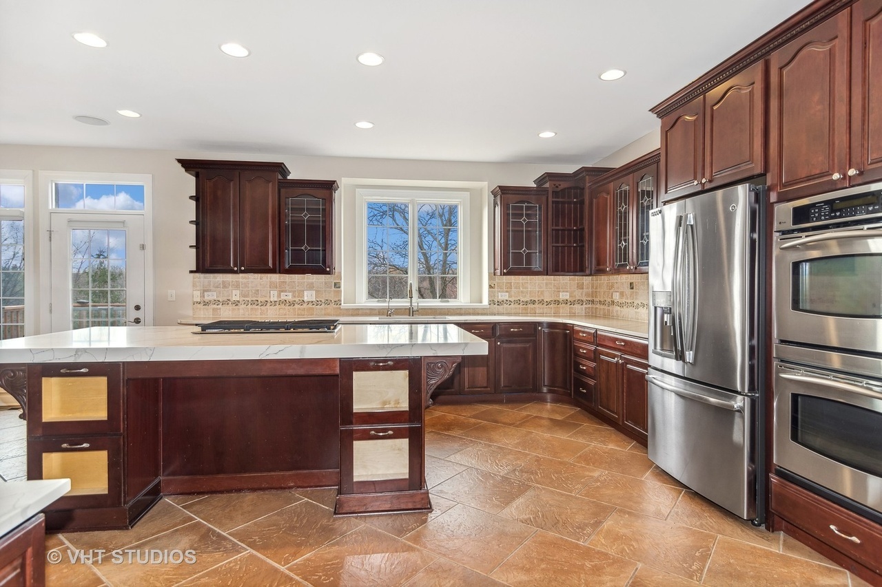 22206 North Prairie Lane Kildeer, IL 60047 - Photo 10 of 34 a kitchen with stainless steel appliances granite countertop a refrigerator and a sink