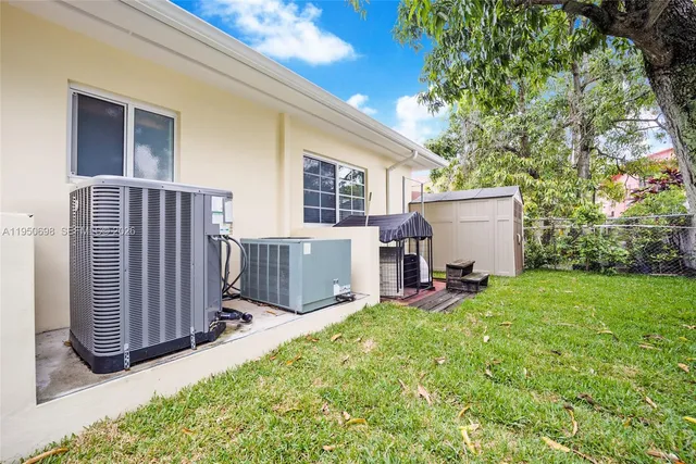 a view of a house with backyard and sitting area