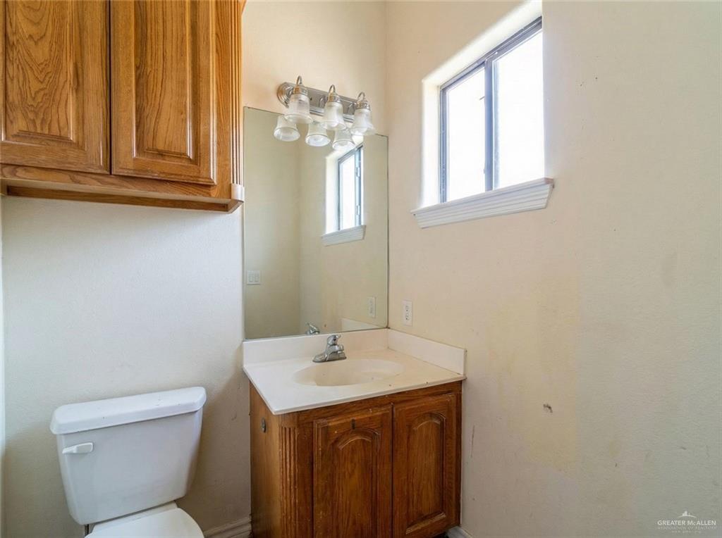 4706 North Trosper Road Mission, TX 78573 - Photo 3 of 12 a bathroom with a sink a toilet and mirror