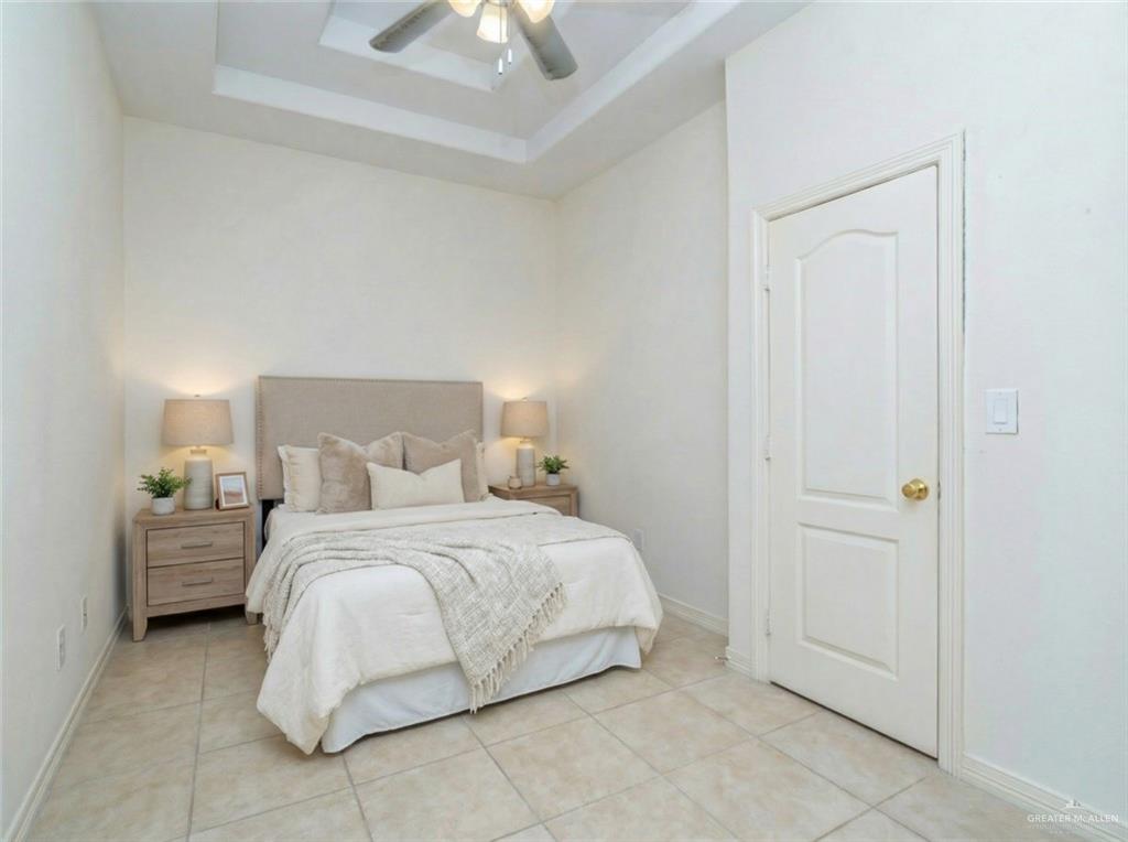 4706 North Trosper Road Mission, TX 78573 - Photo 4 of 12 a bedroom with a bed and a chandelier