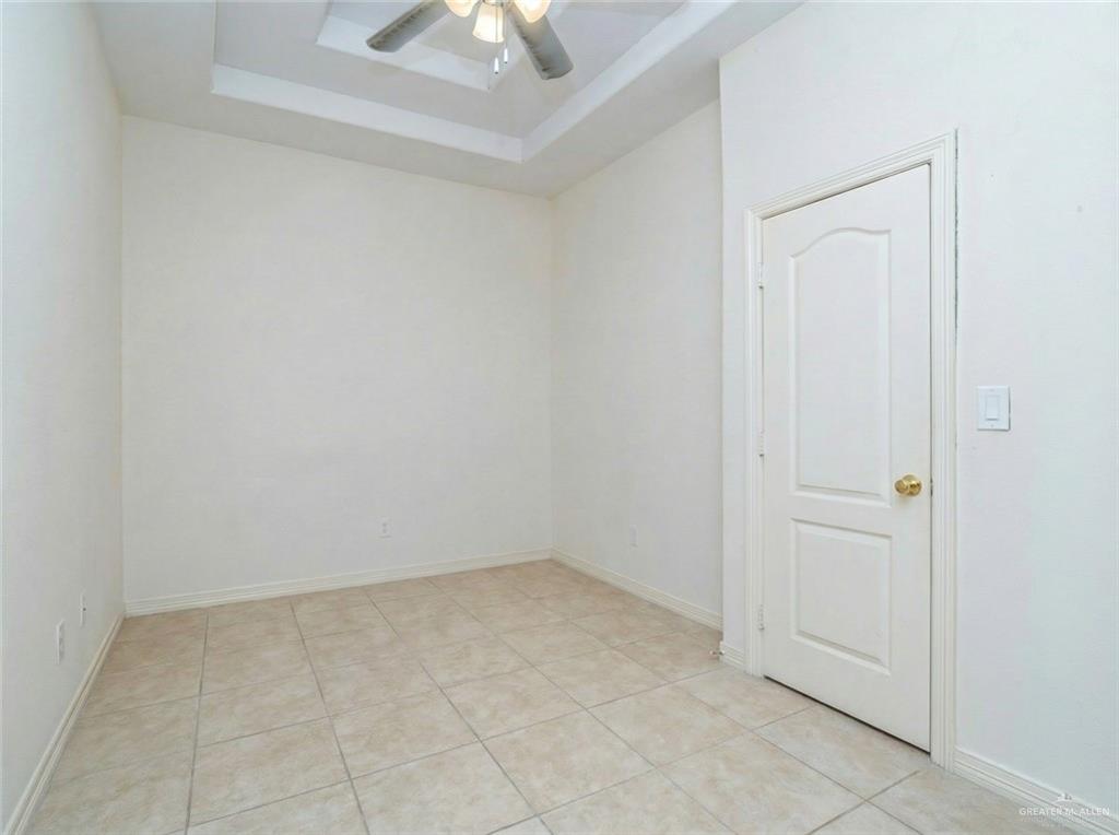 4706 North Trosper Road Mission, TX 78573 - Photo 9 of 12 an empty room with a chandelier fan
