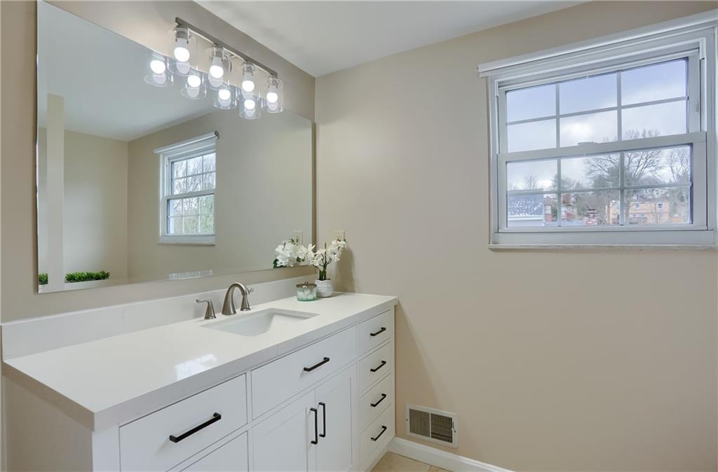 1702 Guyton Road Allison Park, PA 15101 - Photo 19 of 40 a bathroom with a sink vanity and a mirror
