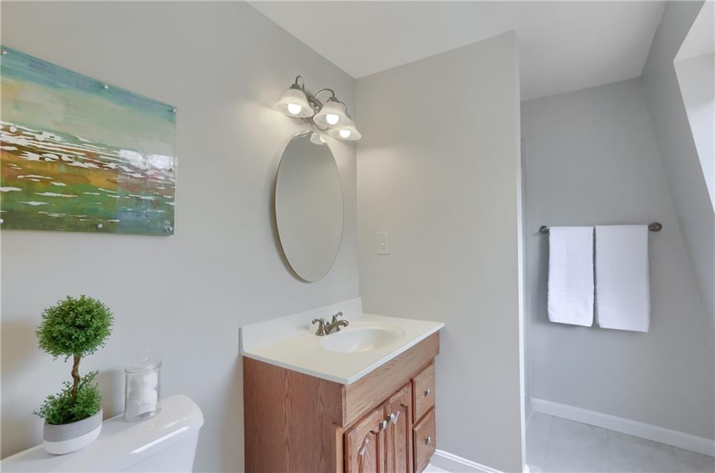 1702 Guyton Road Allison Park, PA 15101 - Photo 23 of 40 a bathroom with a sink a mirror and a potted plant