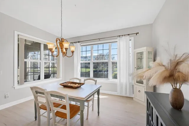 a kitchen with stainless steel appliances granite countertop a stove a sink a refrigerator and island with wooden floor