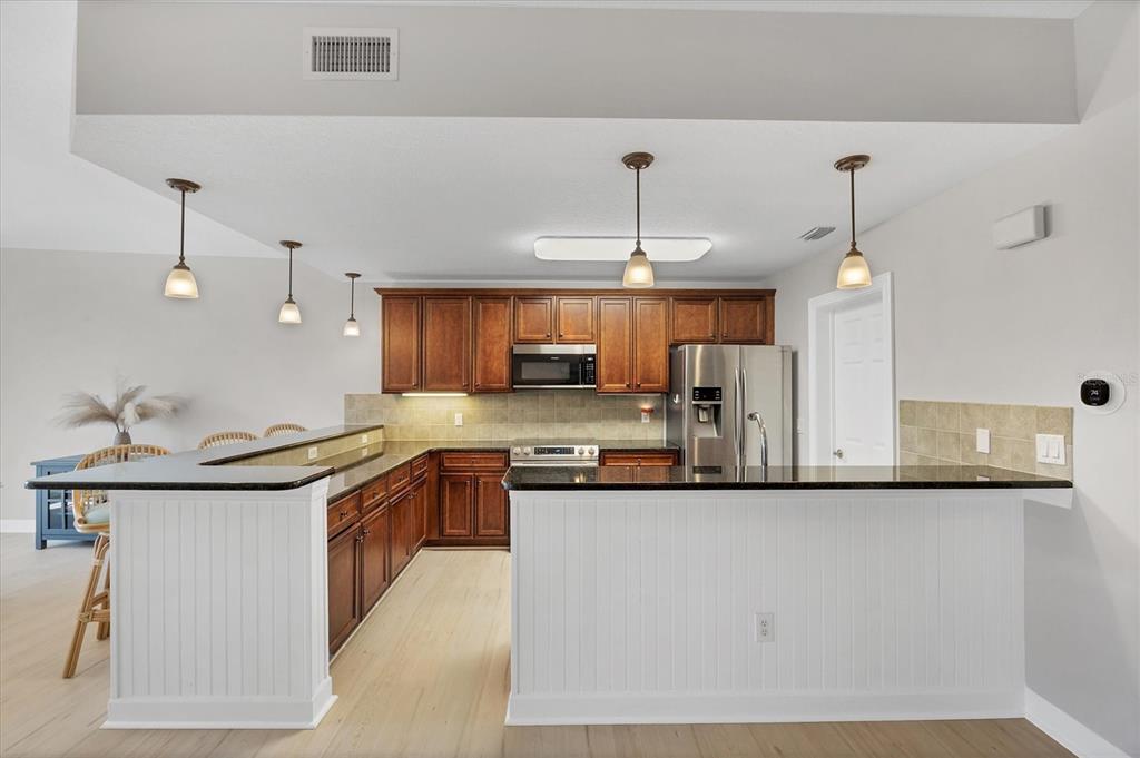 10720 Lemon Creek Loop, Unit 103 Englewood, FL 34224 - Photo 18 of 57 a kitchen with stainless steel appliances granite countertop a sink and cabinets