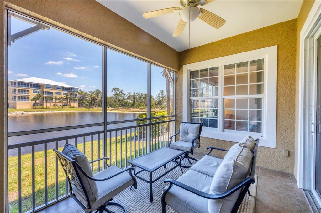 10720 Lemon Creek Loop, Unit 103 Englewood, FL 34224 - Photo 20 of 57 a living room with furniture and a large window