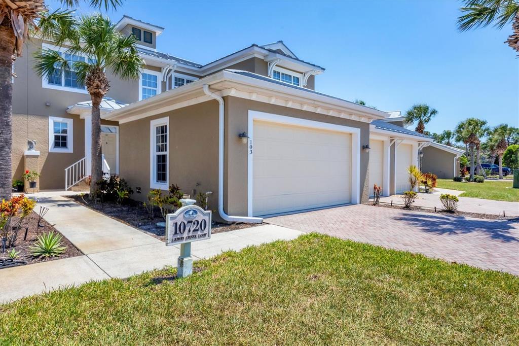 10720 Lemon Creek Loop, Unit 103 Englewood, FL 34224 - Photo 2 of 57 a front view of a house with garden