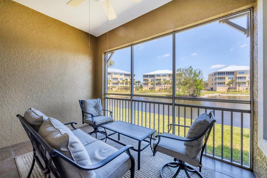 10720 Lemon Creek Loop, Unit 103 Englewood, FL 34224 - Photo 21 of 57 a view of a city from a chairs and table in the balcony