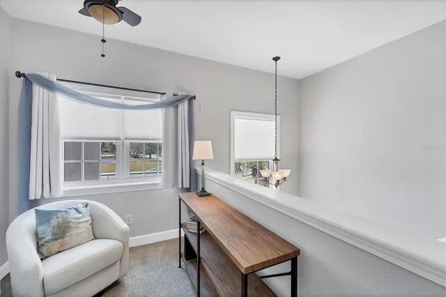 a spacious bedroom with two beds and large windows