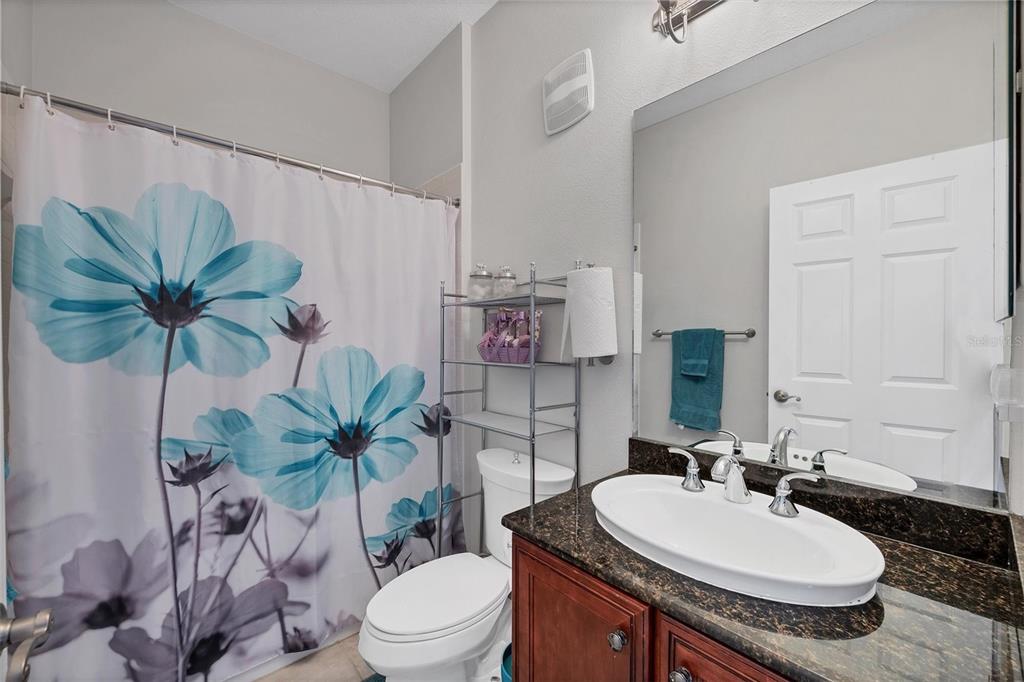 10720 Lemon Creek Loop, Unit 103 Englewood, FL 34224 - Photo 34 of 57 a bathroom with a toilet sink and a mirror
