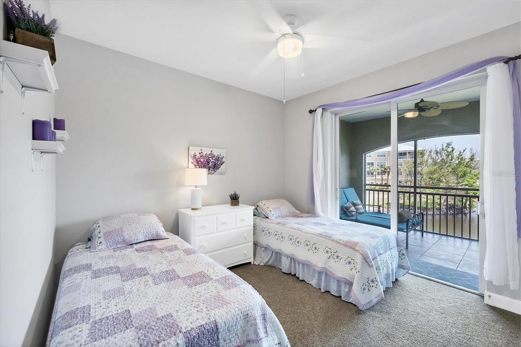 10720 Lemon Creek Loop, Unit 103 Englewood, FL 34224 - Photo 35 of 57 a bedroom with two beds and a large window