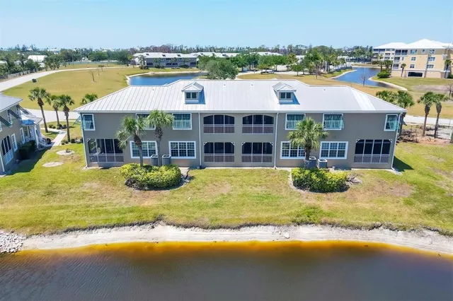 a view of a house with a swimming pool and a yard with potted plants