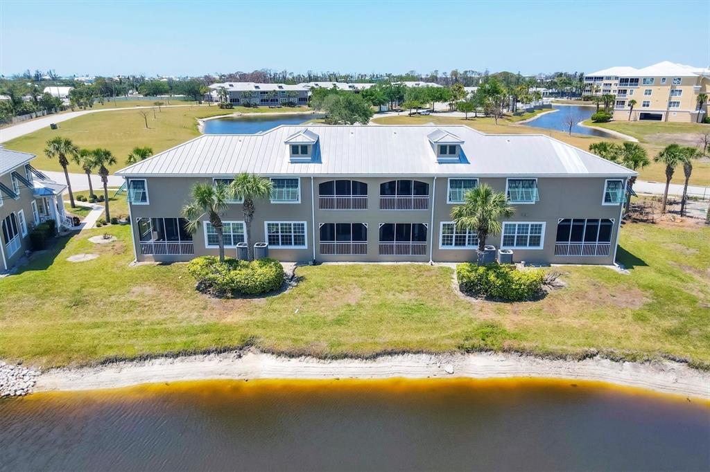 10720 Lemon Creek Loop, Unit 103 Englewood, FL 34224 - Photo 38 of 57 a view of a house with a swimming pool and outdoor space