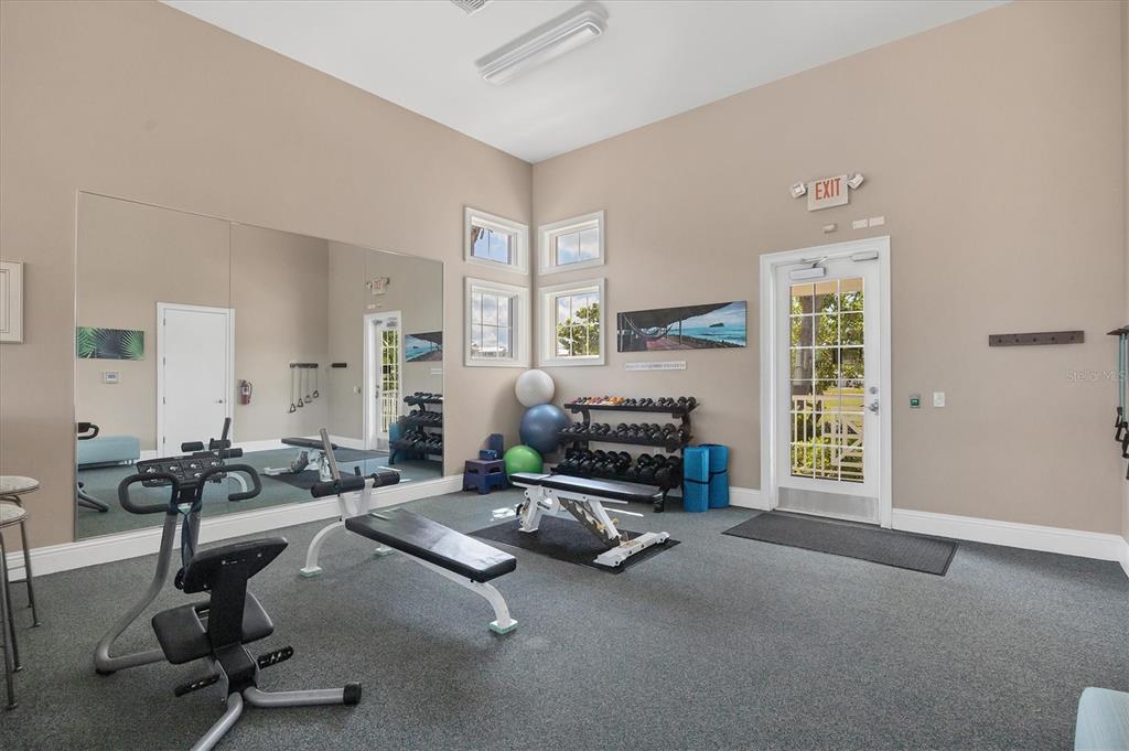 10720 Lemon Creek Loop, Unit 103 Englewood, FL 34224 - Photo 45 of 57 a room with gym equipment and large window