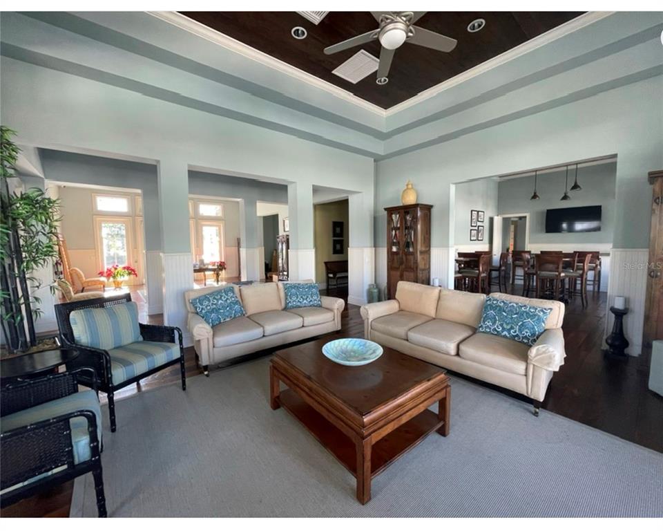 10720 Lemon Creek Loop, Unit 103 Englewood, FL 34224 - Photo 55 of 57 a living room with furniture a fireplace and a chandelier