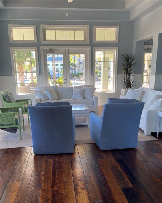 10720 Lemon Creek Loop, Unit 103 Englewood, FL 34224 - Photo 56 of 57 a living room with couches and a dining table with wooden floor
