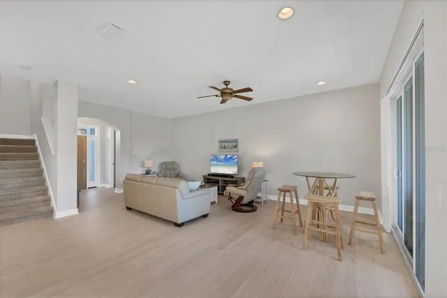 a dining room with furniture a chandelier and wooden floor