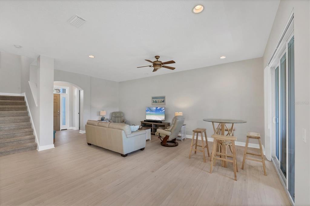 10720 Lemon Creek Loop, Unit 103 Englewood, FL 34224 - Photo 9 of 57 a living room with furniture and a chandelier