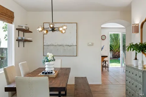 a dining room with furniture and wooden floor