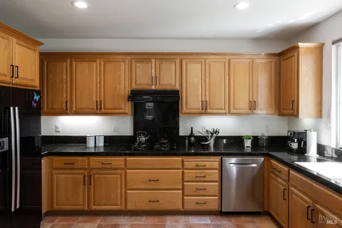a kitchen with sink and refrigerator