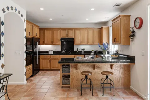 a kitchen with a stove and a refrigerator