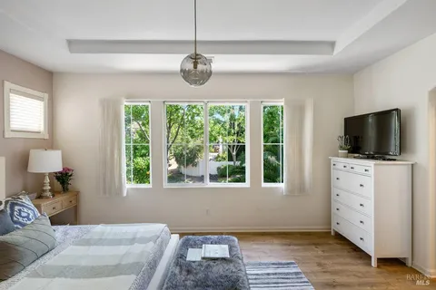 a bedroom with a bed and a potted plant