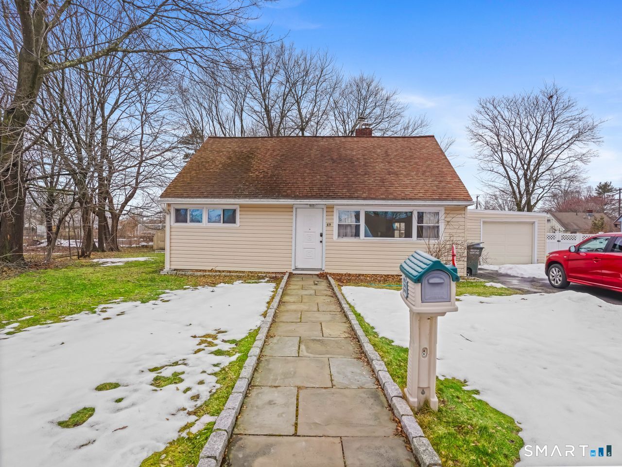 a front view of house with yard and green space