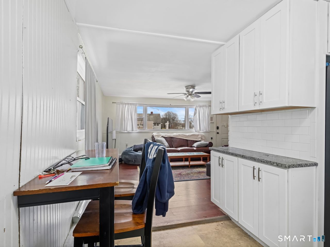 69 Seaver Circle Bridgeport, CT 06606 - Photo 15 of 29 a kitchen with stainless steel appliances kitchen island granite countertop a table chairs in it and wooden floors