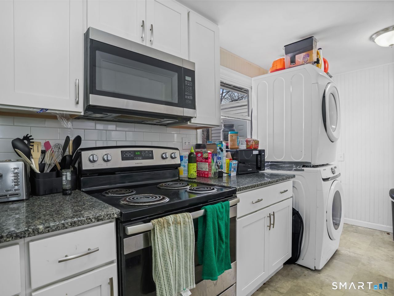 69 Seaver Circle Bridgeport, CT 06606 - Photo 17 of 29 a kitchen with stainless steel appliances granite countertop a stove a sink and a microwave