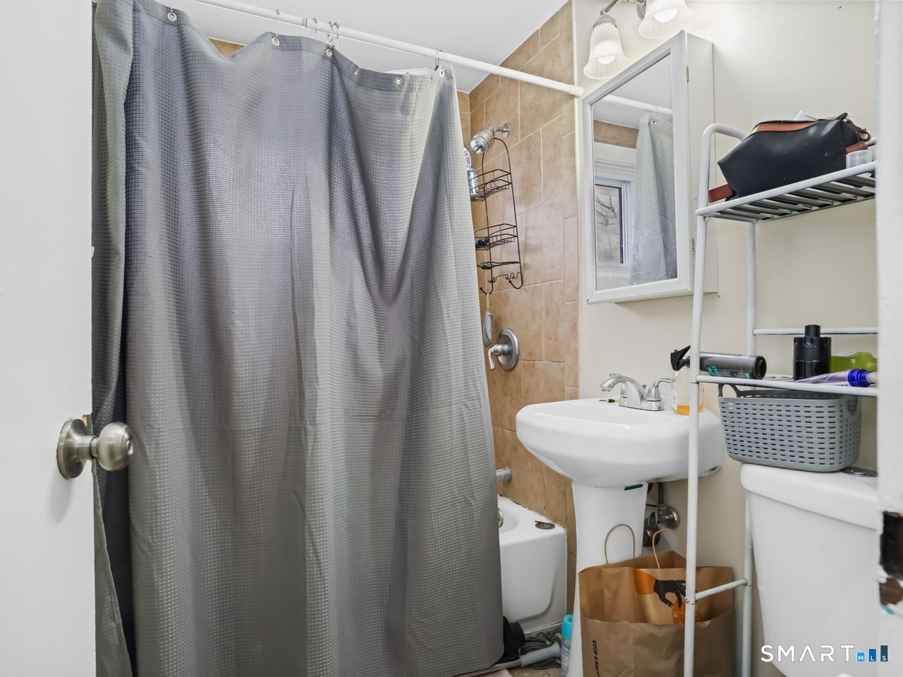 69 Seaver Circle Bridgeport, CT 06606 - Photo 18 of 29 a bathroom with a sink toilet and shower