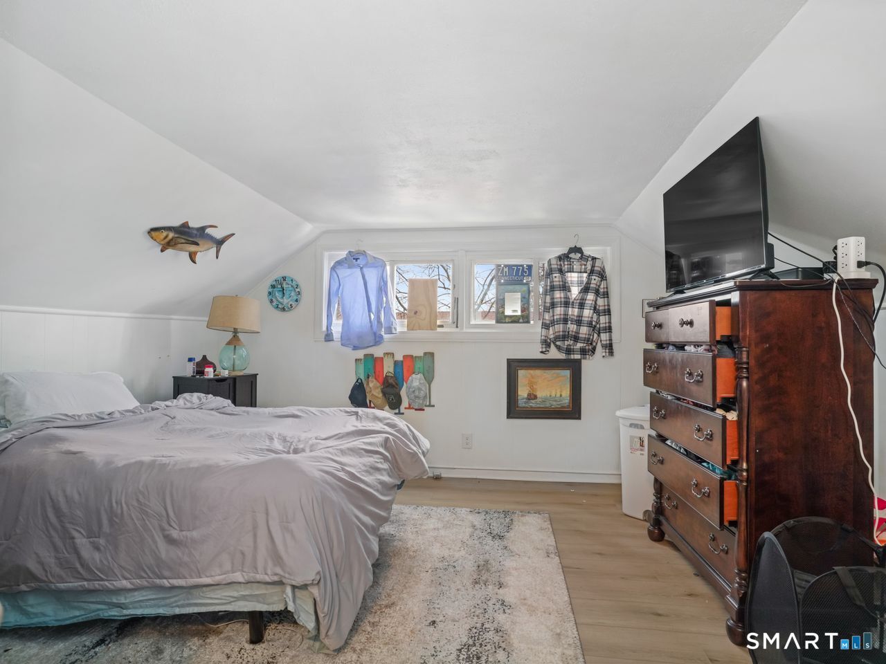 69 Seaver Circle Bridgeport, CT 06606 - Photo 24 of 29 a bedroom with a bed a flat screen tv and dresser