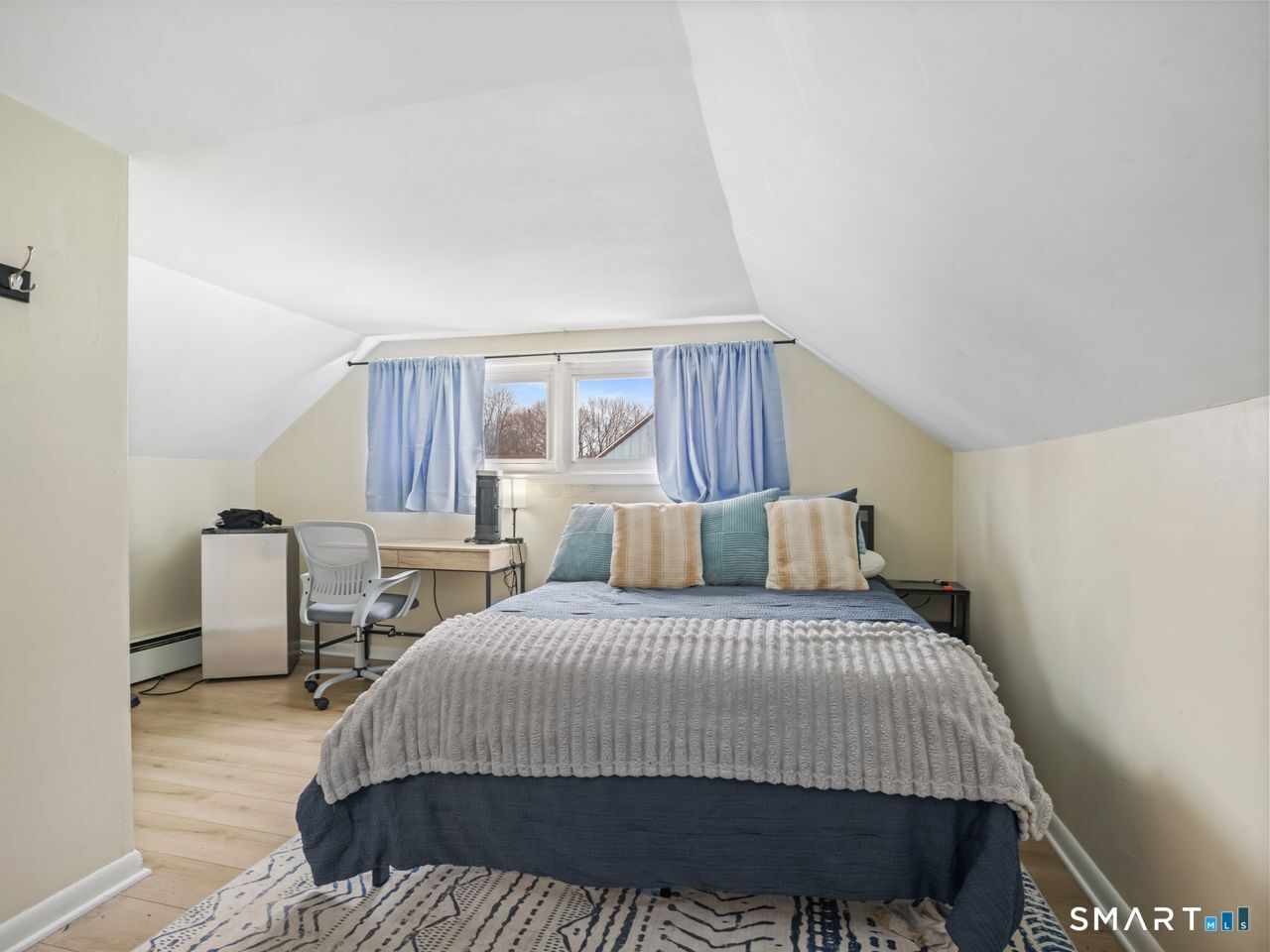 69 Seaver Circle Bridgeport, CT 06606 - Photo 27 of 29 a bedroom with a bed a table and dresser