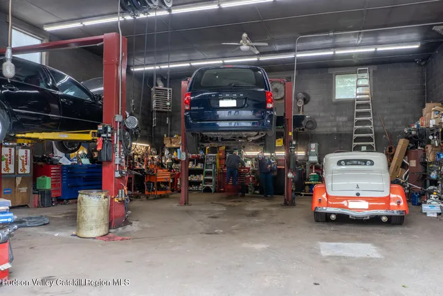 a view of parking area with a garage