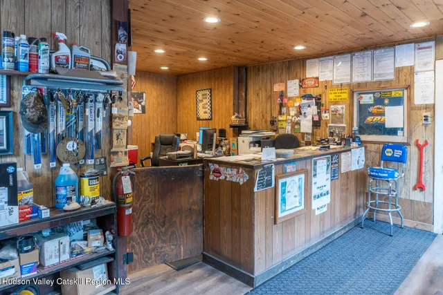 a kitchen with stainless steel appliances granite countertop a stove a refrigerator and a dining table with wooden floor