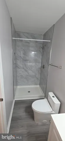 a bathroom with a toilet and a shower