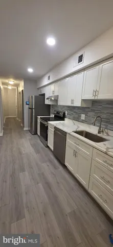 a kitchen with stainless steel appliances granite countertop a sink and cabinets