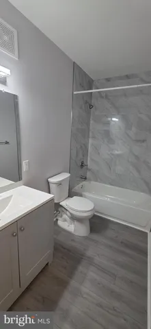 a bathroom with a toilet a sink and shower