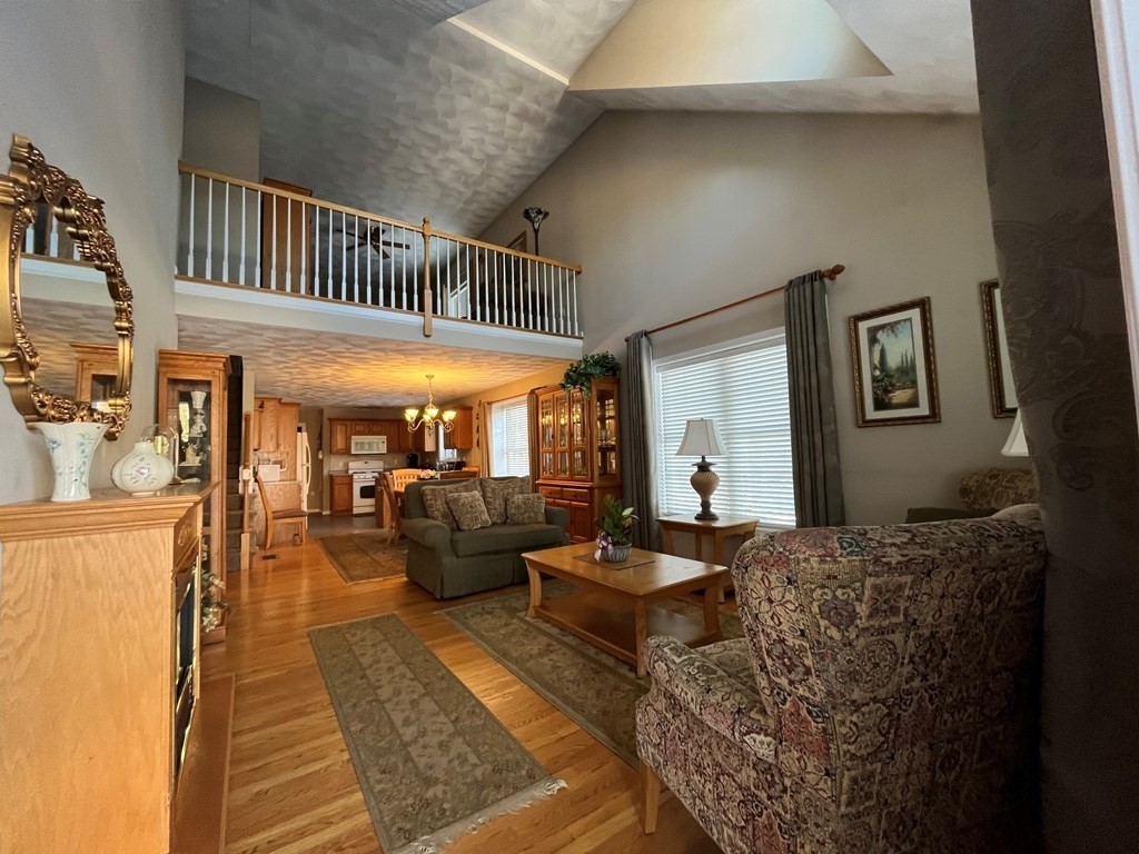9 Flat Rock Road, Unit 9 Windham, NH 03087 - Photo 3 of 32 a living room with furniture and a window